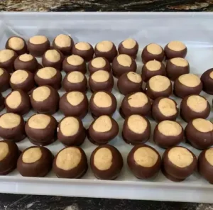 Tray of homemade buckeye candies with peanut butter centers dipped in chocolate