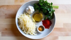 Fresh ingredients for baked tater tots, including shredded potatoes and spices