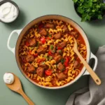 One pot goulash in Dutch oven with tender beef, paprika sauce, and egg noodles